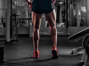 A close-up shot of a man’s muscular calves