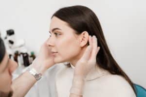 Woman being examined by surgeon to see if she’s an otoplasty candidate