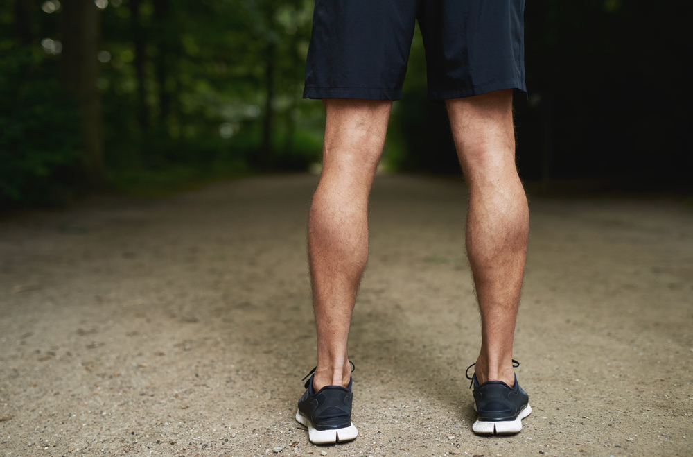 Close-up shot of a man's calves after calf implants in Miami